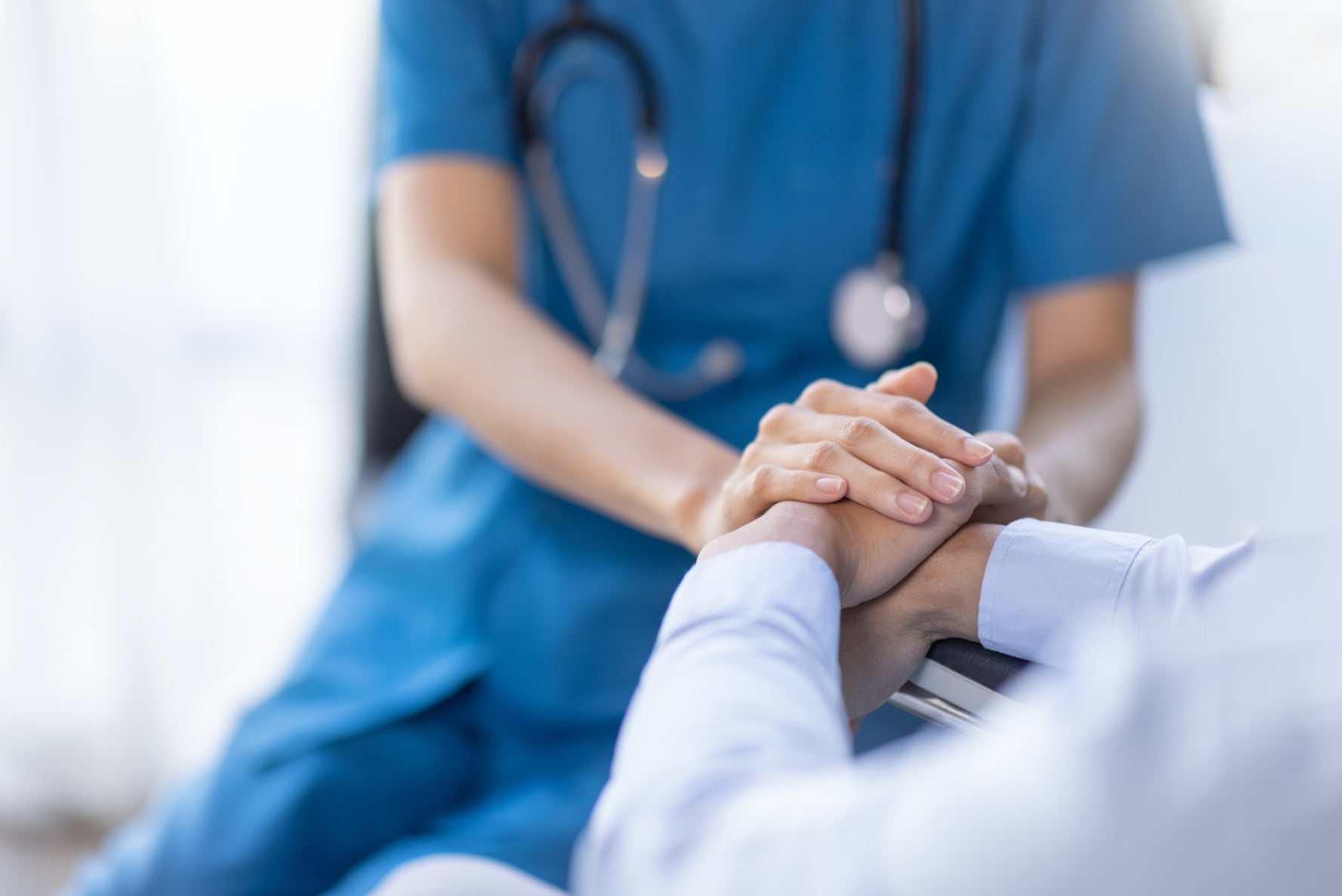 A female nurse hold her senior patient's hand (stock image)