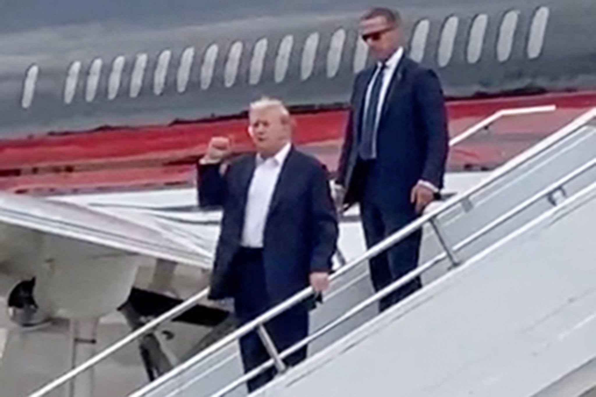 Former president Donald Trump gestures as he arrives at Milwaukee Mitchell International Airport a day after he survived an assassination attempt at a rally in Butler, Pennsylvania. Trump’s media company’s stock rose by 33 percent in premarket trading the Monday after the assassination attempt