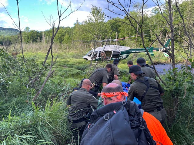 <p>Maine search and rescue personnel escort Michael Altmaier, a man who went missing and was later found in a bog near Mount Blue State Park Scenic Overlook, to a waiting helicopter on July 12, 2024</p>