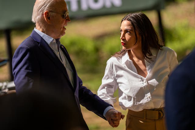 <p>President Joe Biden (left) and Representative Alexandria Ocasio-Cortez (right) pictured speaking in April. Ocasio-Cortez condemned an anonymous Democrat who said they are resigned to a victory by Donald Trump in November after he survived an assassination attempt </p>