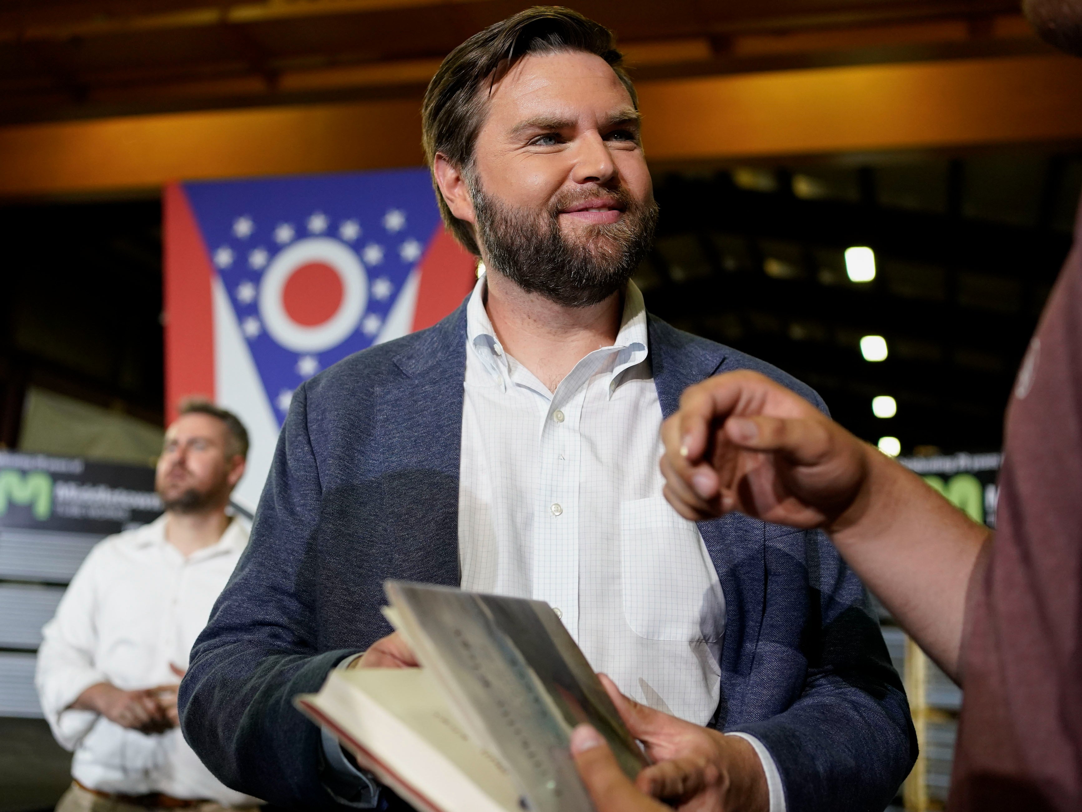 Vance holds a copy of his book Hillbilly Elegy as he meets voters in his hometown after announcing his 2022 Senate run