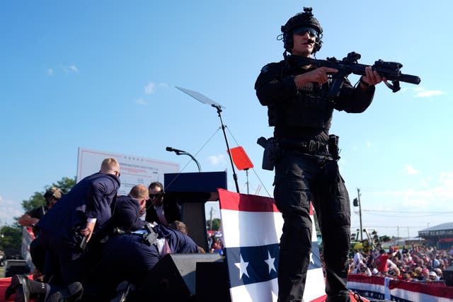 <p>Republican presidential candidate former President Donald Trump is covered by U.S. Secret Service agents at a campaign rally in Butler, Pennsylvania. </p>