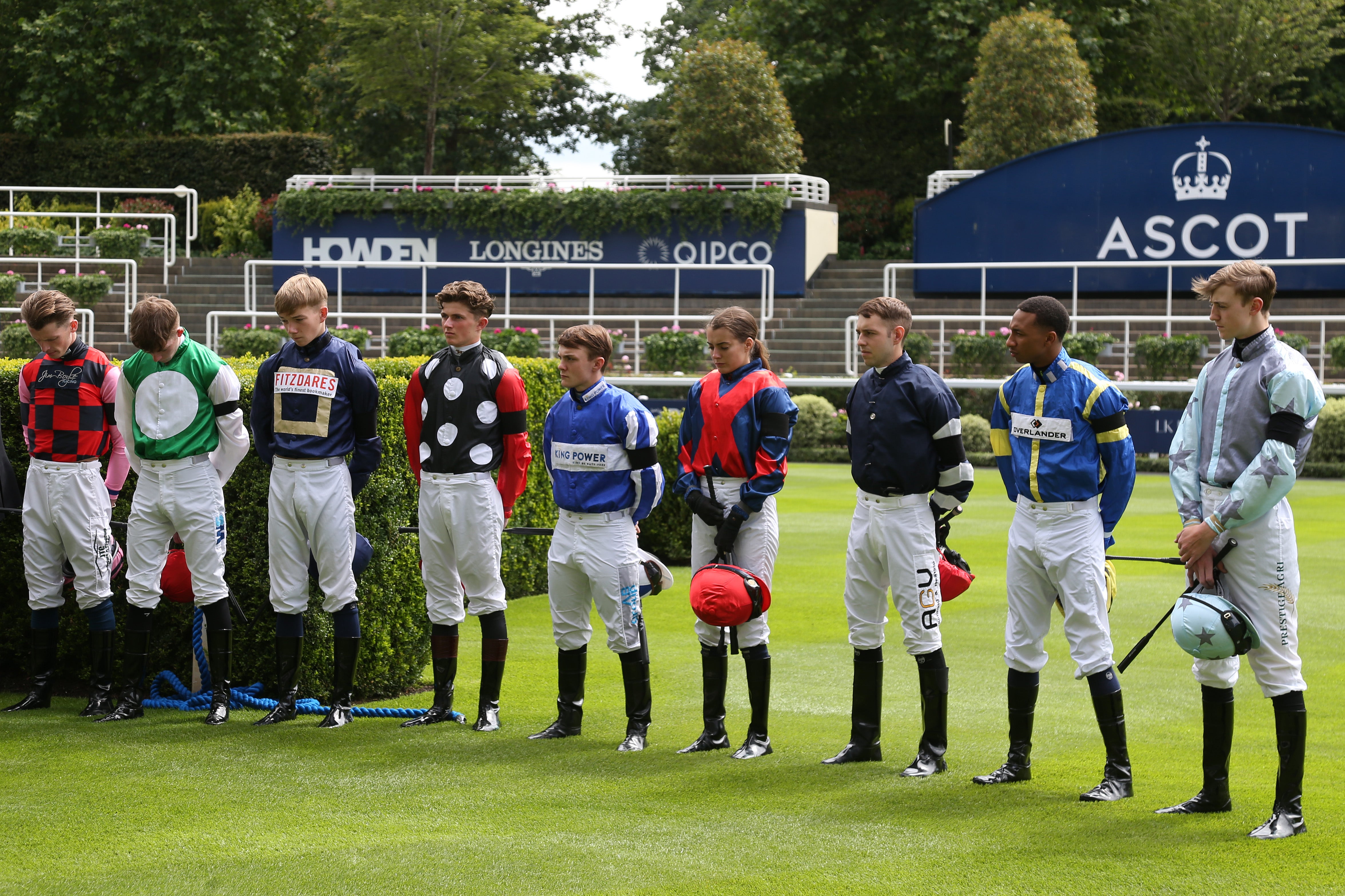 Jockeys wear black armbands and observe a minutes silence in memory of the family of John Hunt at Ascot Racecourse