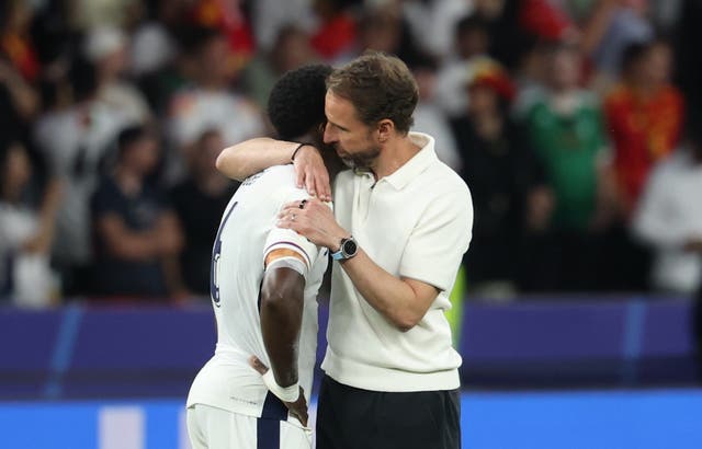 <p>Gareth Southgate embraces Marc Guehi at full-time against Spain</p>