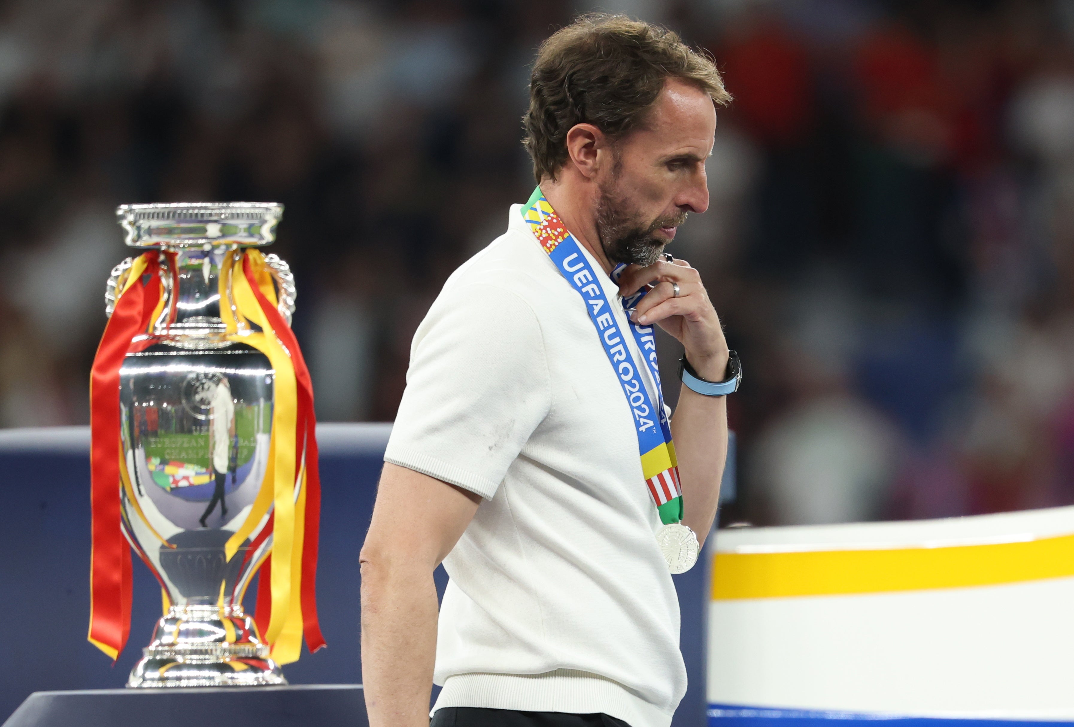 England head coach Gareth Southgate walks past the trophy