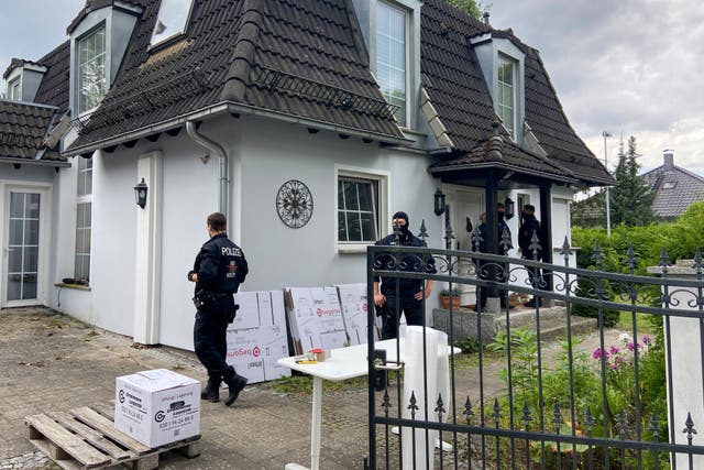 <p>Police at a house in Falkensee near Berlin. Searches were conducted in four German states</p>