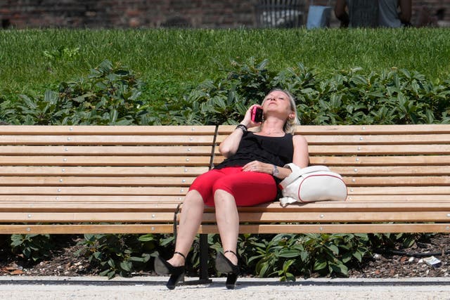 <p>A woman sunbathes in a park in Milan, Italy, Tuesday</p>