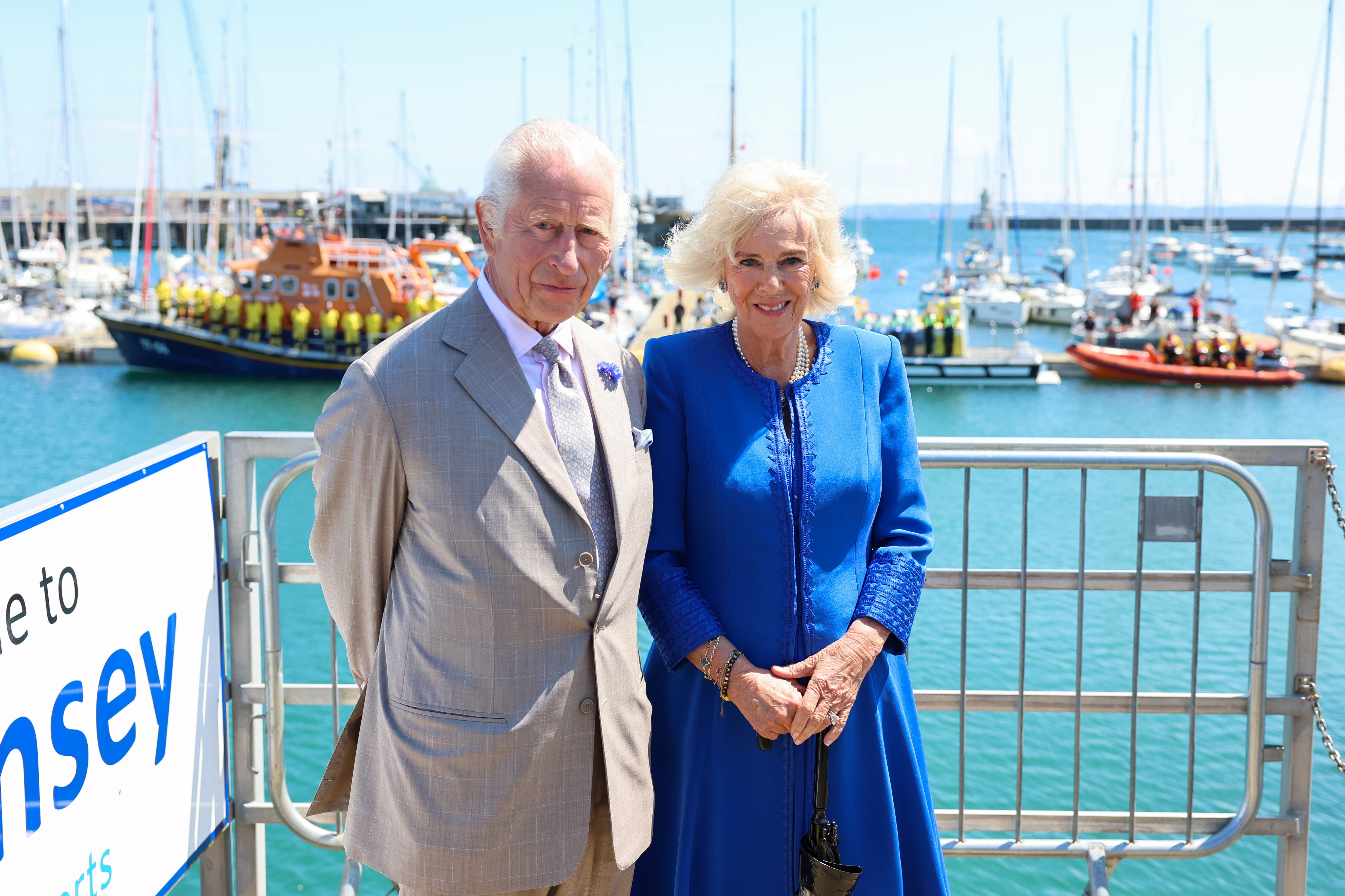 The King and Queen Camilla pose in front of the RNLI Lifeboats (Chris Jackson/PA)