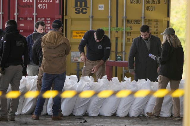 <p>Agents from Paraguay’s anti-drug agency, Senad, inspect sacks of sugar at the port of Caacupemi in Asuncion, Paraguay</p>
