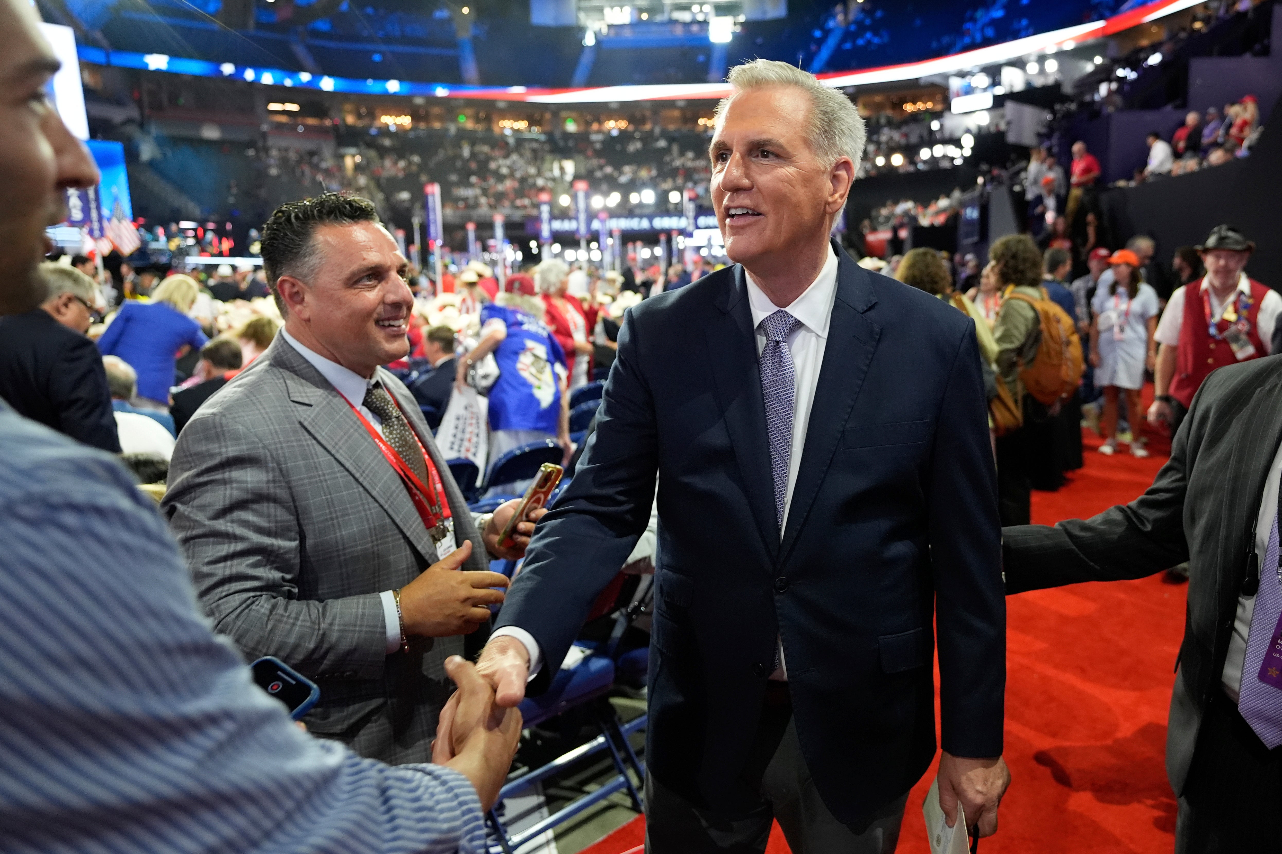 Kevin McCarthy, pictured, shakes hands with a delegate at the Republican National Convention on Monday. The former speaker falsely claimed there has not been an attempted presidential assassination since the 1960s during a speech on Tuesday