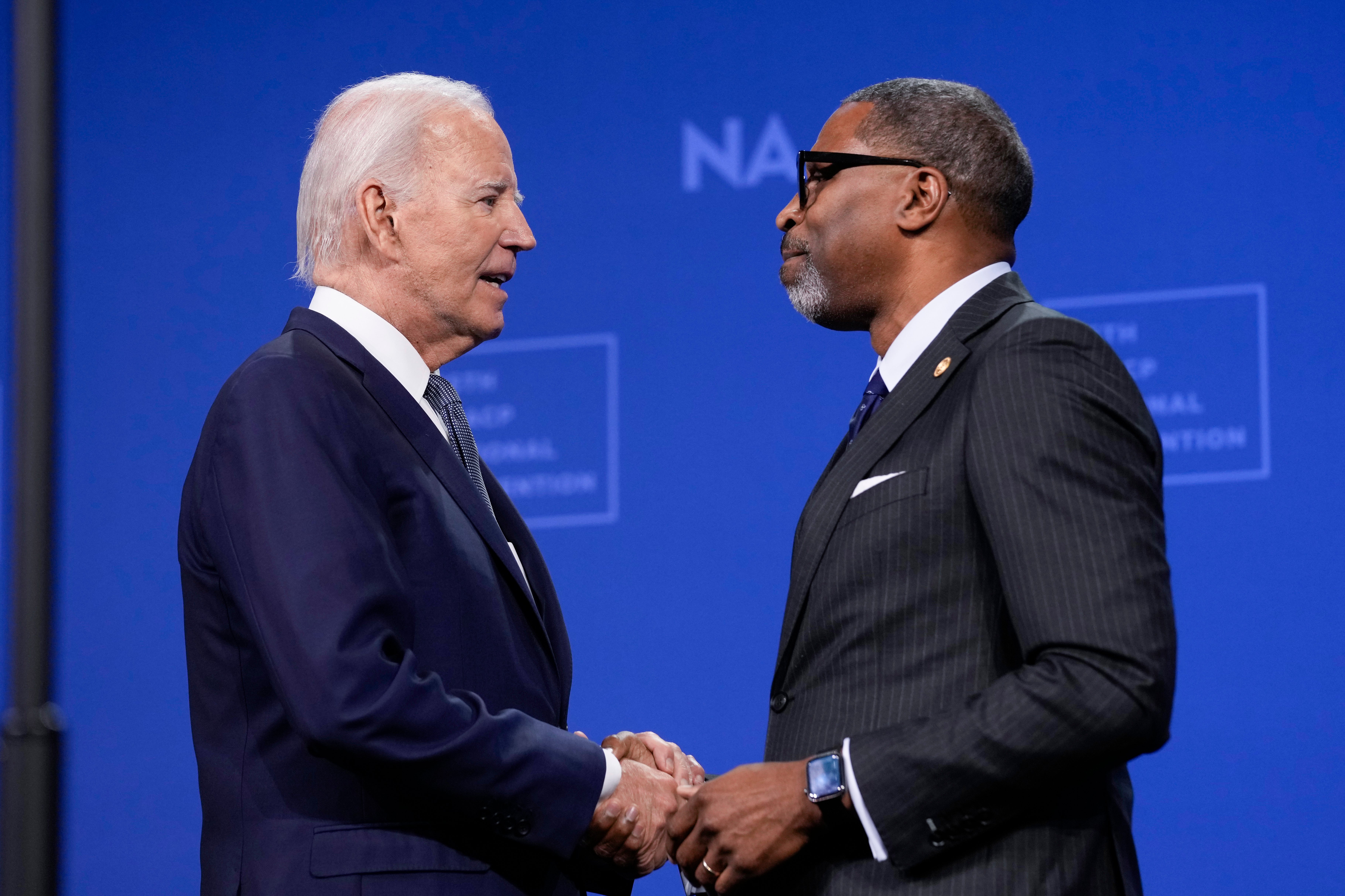 President Joe Biden is welcomed by NAACP President and CEO Derrick Johnson before speaking at the 115th NAACP National Convention in Las Vegas, on July 16, 2024