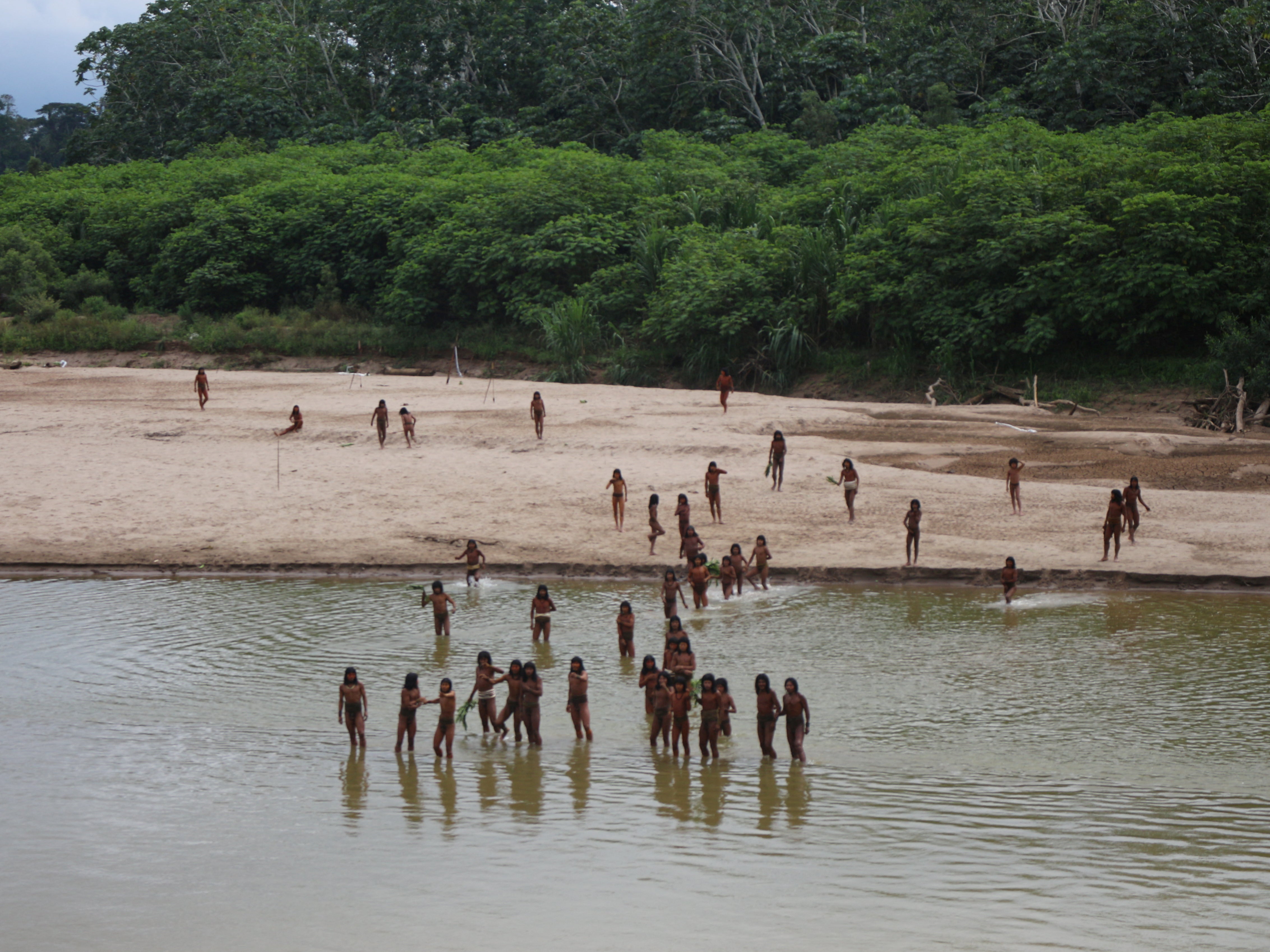 Members of the Mashco Piro, a reclusive tribe in the Amazon, gather on the banks of the Las Piedras river on 27 June 2024