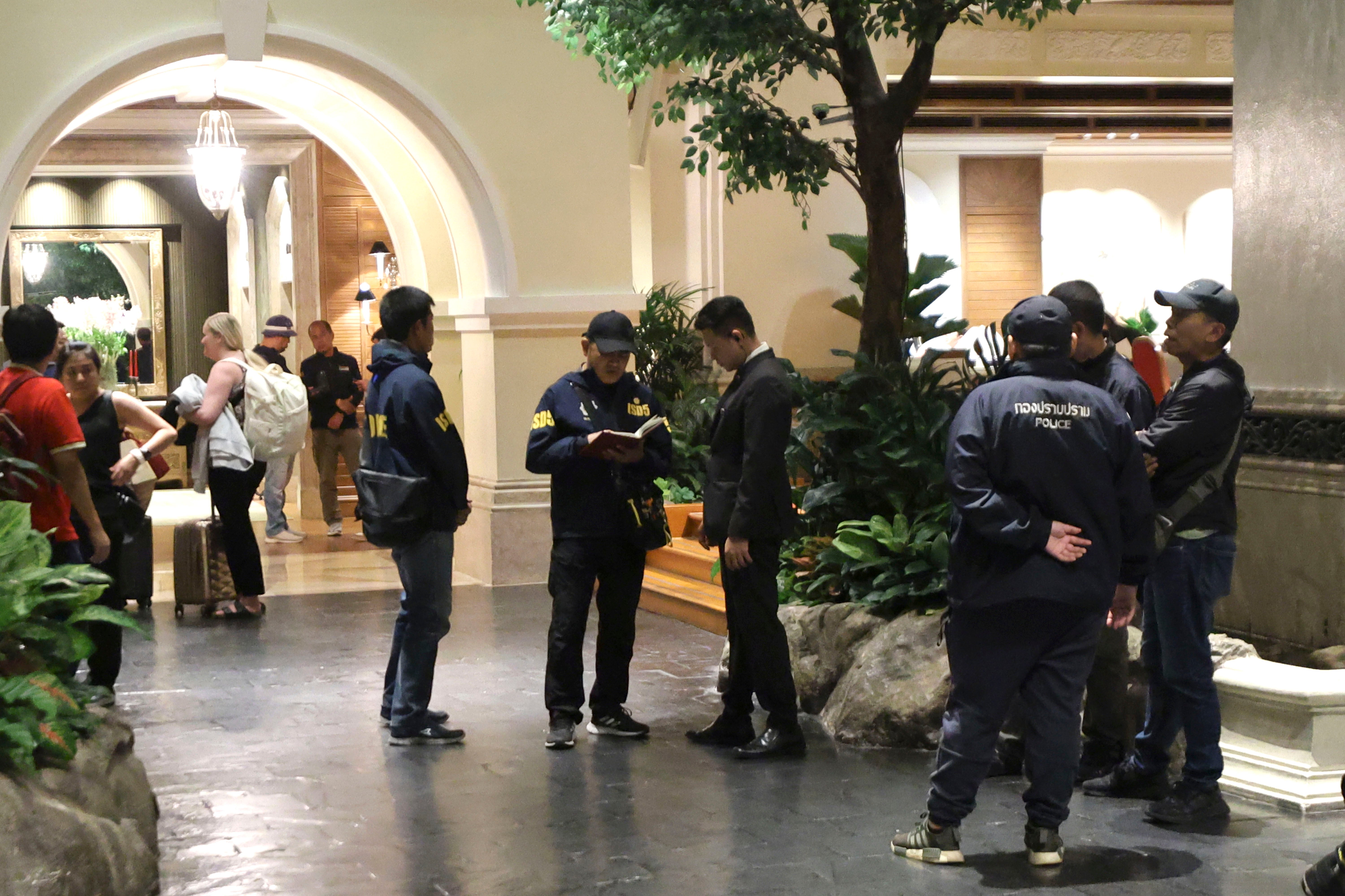 Police officers talk to a staff member at the Grand Hyatt Erawan Hotel in Bangkok, Thailand, Tuesday, July 16