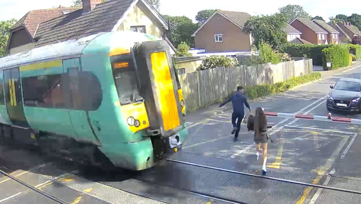 ‘Reckless’ pedestrians miss being hit by train by seconds in terrifying level crossing CCTV
