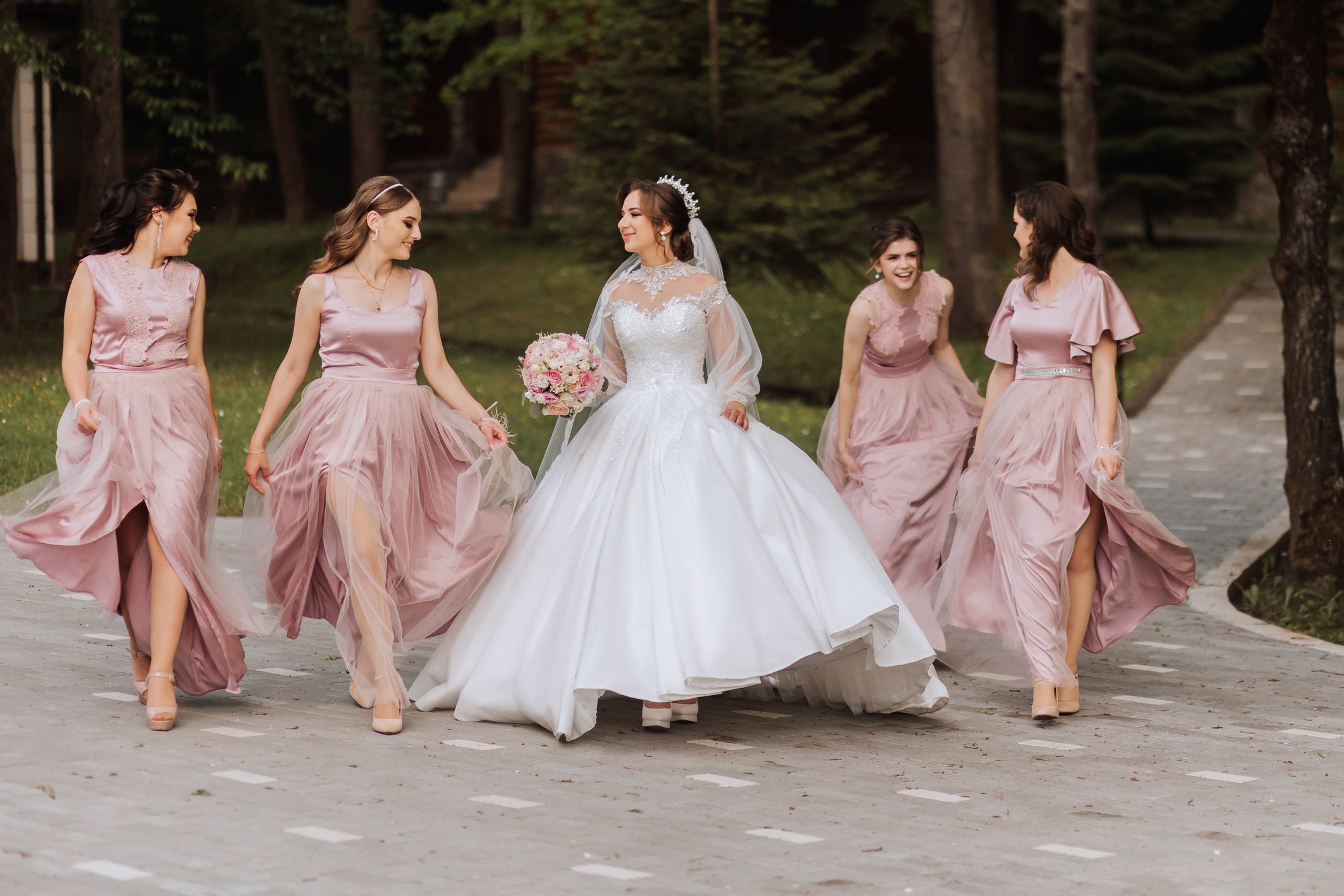 A bride with her bridesmaids. Much of the hard work that goes into planning a wedding happens long before the bride walks down the aisle.