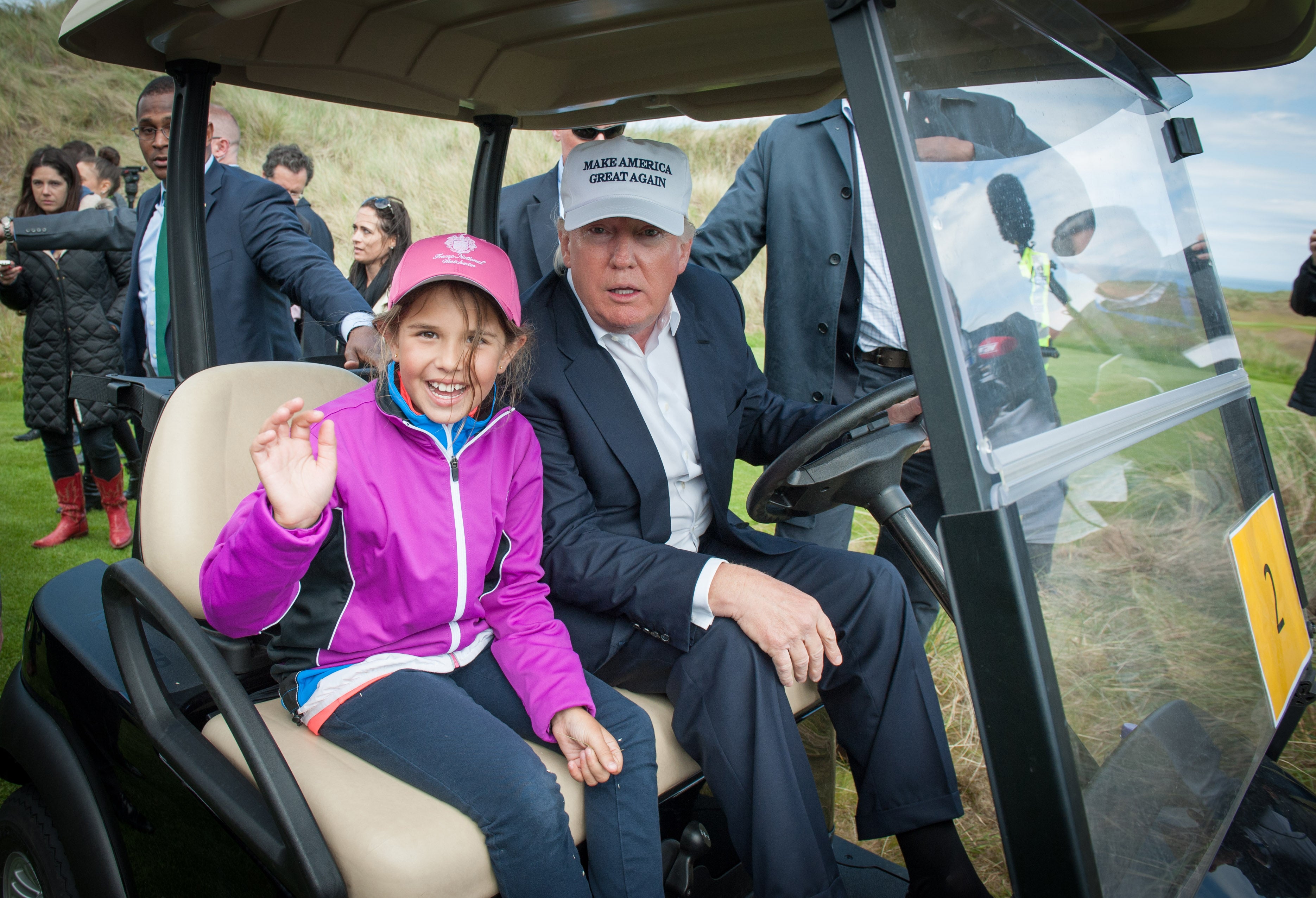 Donald Trump travels with his granddaughter Kai during a tour of his International Golf Links course north of Aberdeen, Scotland on June 25, 2016