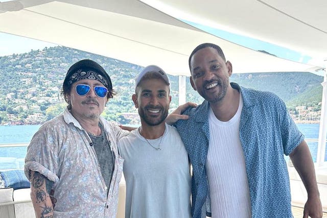 <p>Johnny Depp (left) and Will Smith (right) pose with Egyptian singer Ahmed Saad</p>
