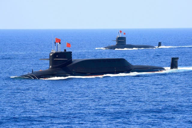 <p>Chinese submarines surface during a naval display in the South China Sea on 12 April 2018</p>