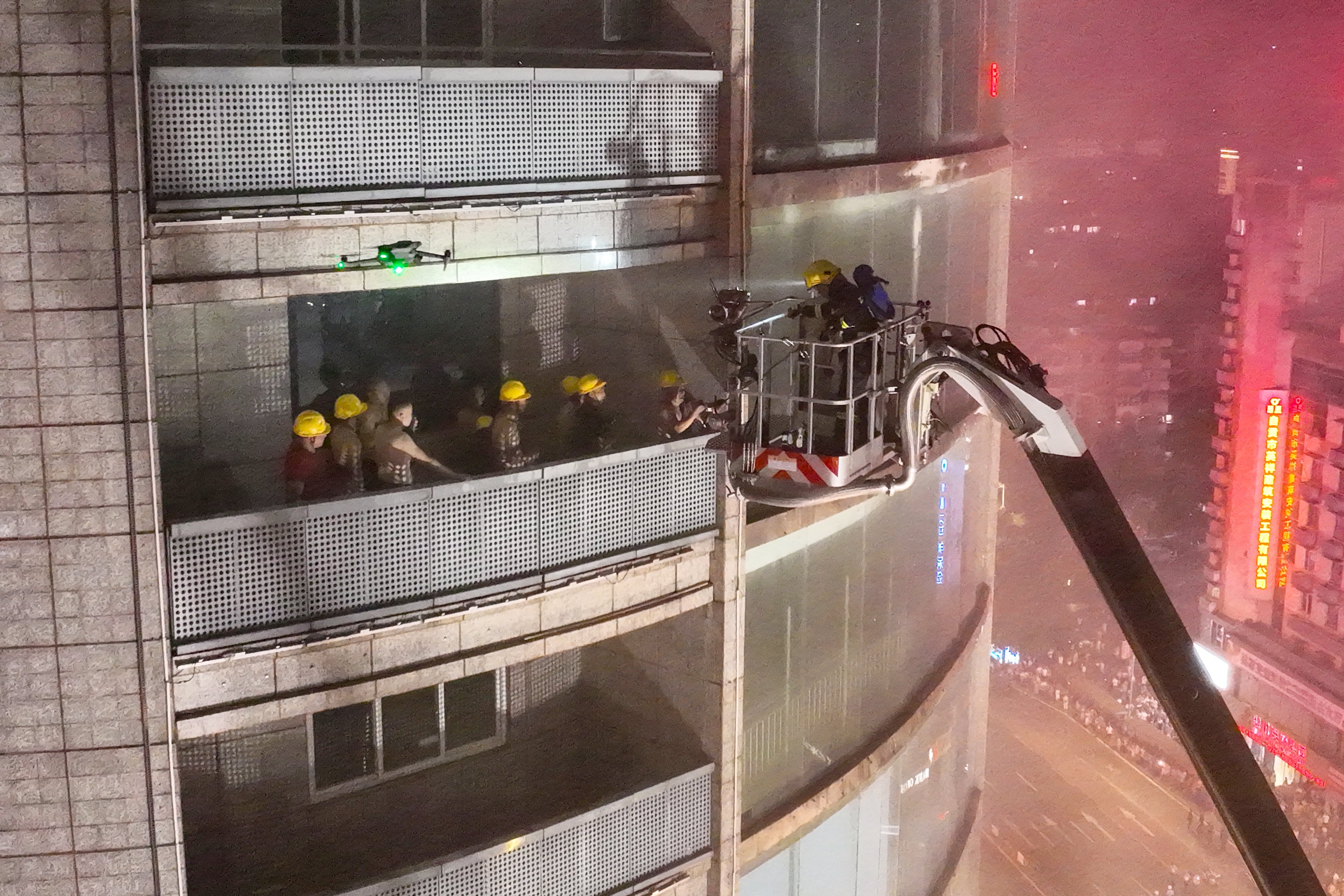 Firefighters extinguish a fire tearing through a shopping centre in Zigong in China's southwestern Sichuan province