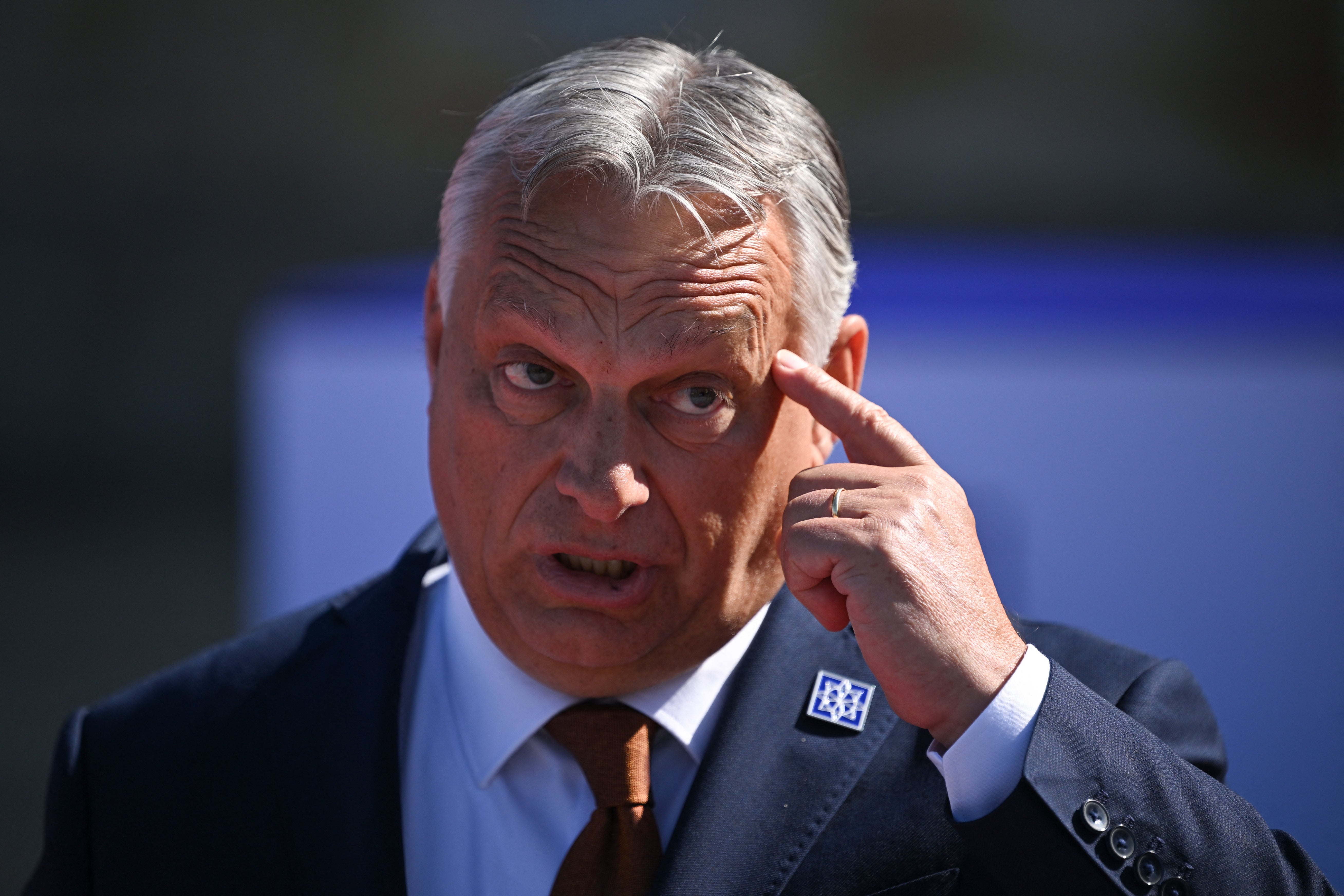 Hungary's Prime Minister Viktor Orban gestures as he speaks to media after arriving to attend the European Political Community meeting at Blenheim Palace in Woodstock