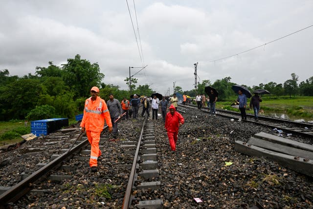 <p>Railway workers and National Disaster Response Force (NDRF) personnel inspect the accident site of passenger train in India </p>