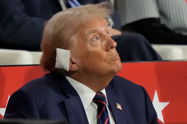 <p>Donald Trump at the Republican National Convention in Milwaukee, Wisconsin wearing an ear bandage. Trump’s arrival at a hospital in Pennsylvania after his attempted assassination on Saturday, July 13, was recorded by a supporter already at the facility </p>