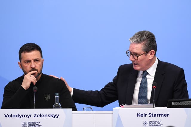 <p>Sir Keir Starmer touched Mr Zelensky’s shoulder as he highlighted the Ukrainian leader’s comments calling for air defences to protect children as they return to school </p>