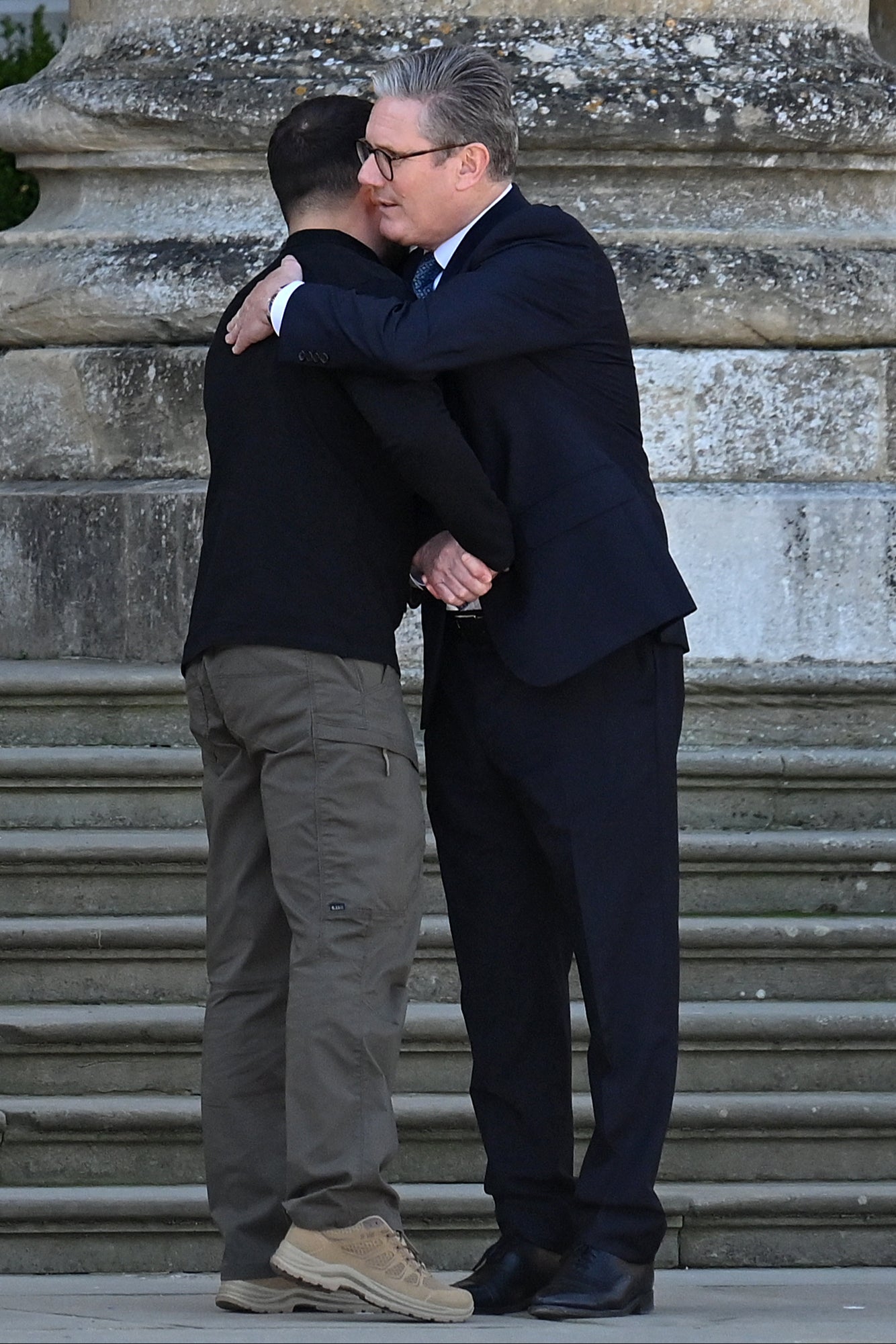 Ukrainian president Volodymyr Zelensky and British prime minister Sir Keir Starmer embrace in the grand entrance of Blenheim Palace