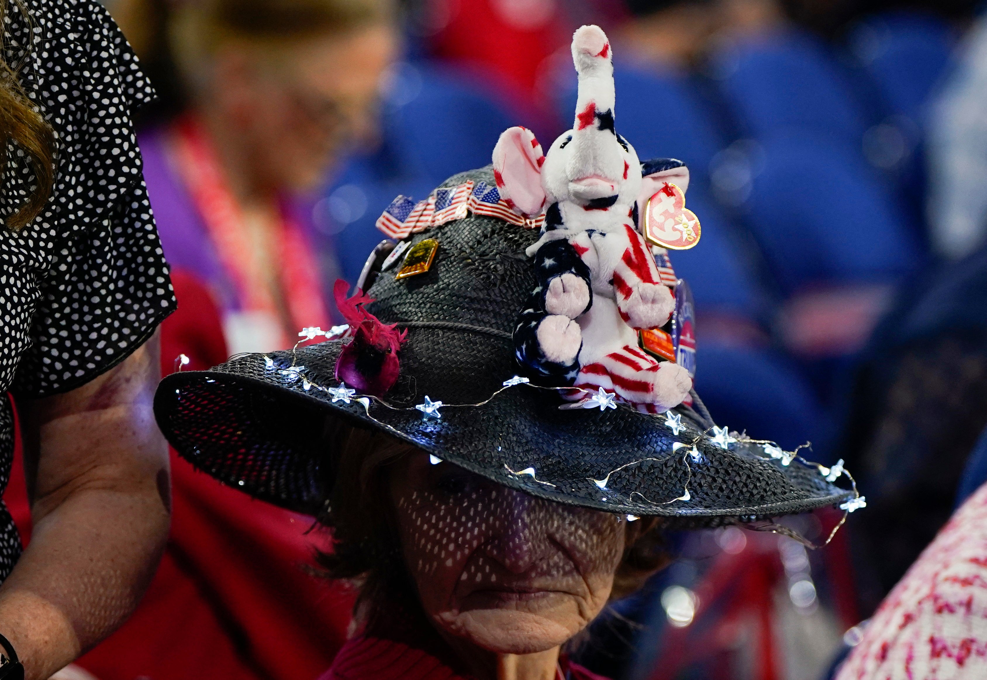 An attendee wears a black netted hat featuring an elephant, the symbol of the Republican Party since 1874