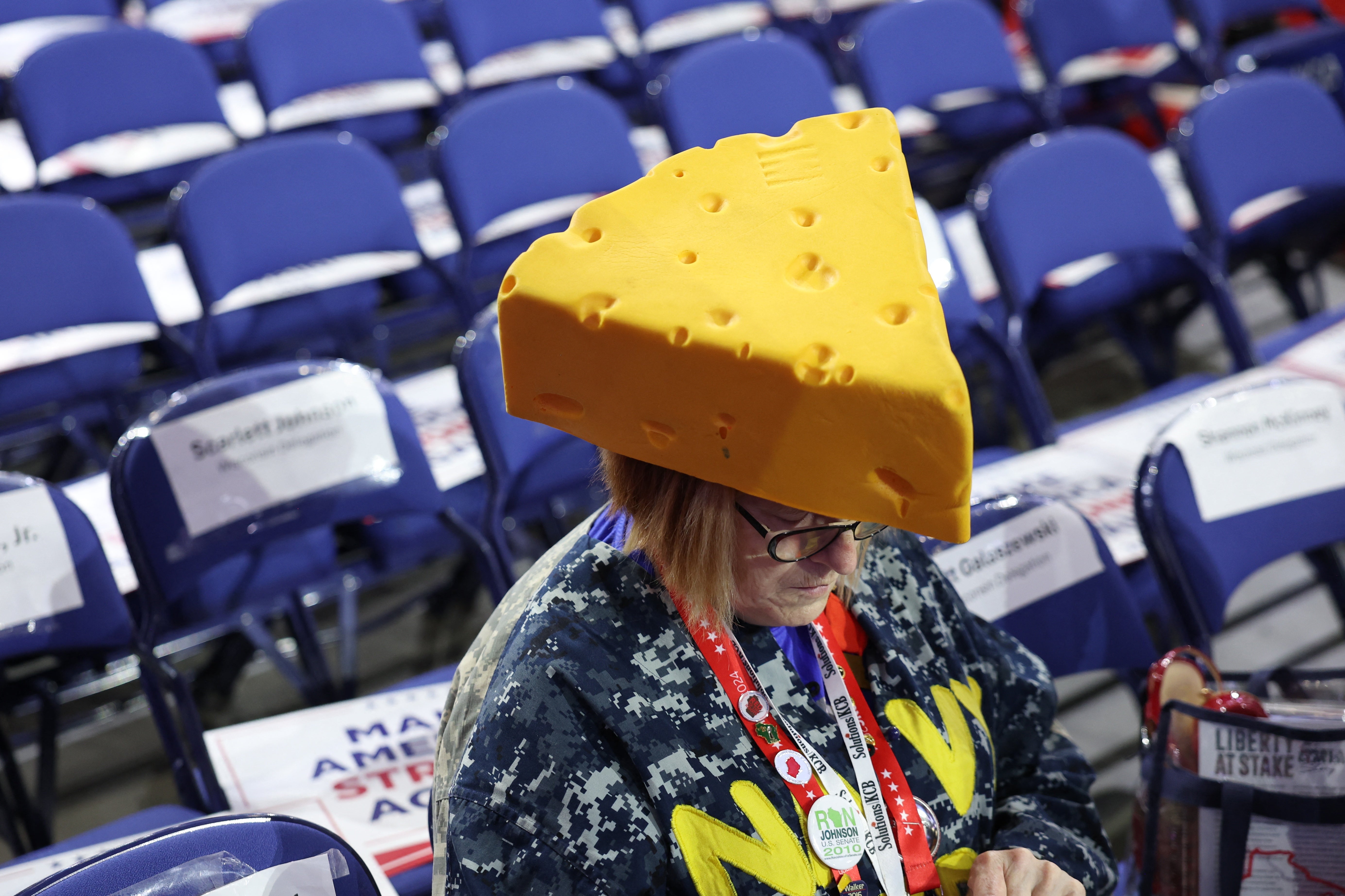 A delegate wears a cheesehead hat. Cheeseheads are symbols of citizens of Wisconsin, particularly fans of the Green Bay Packers