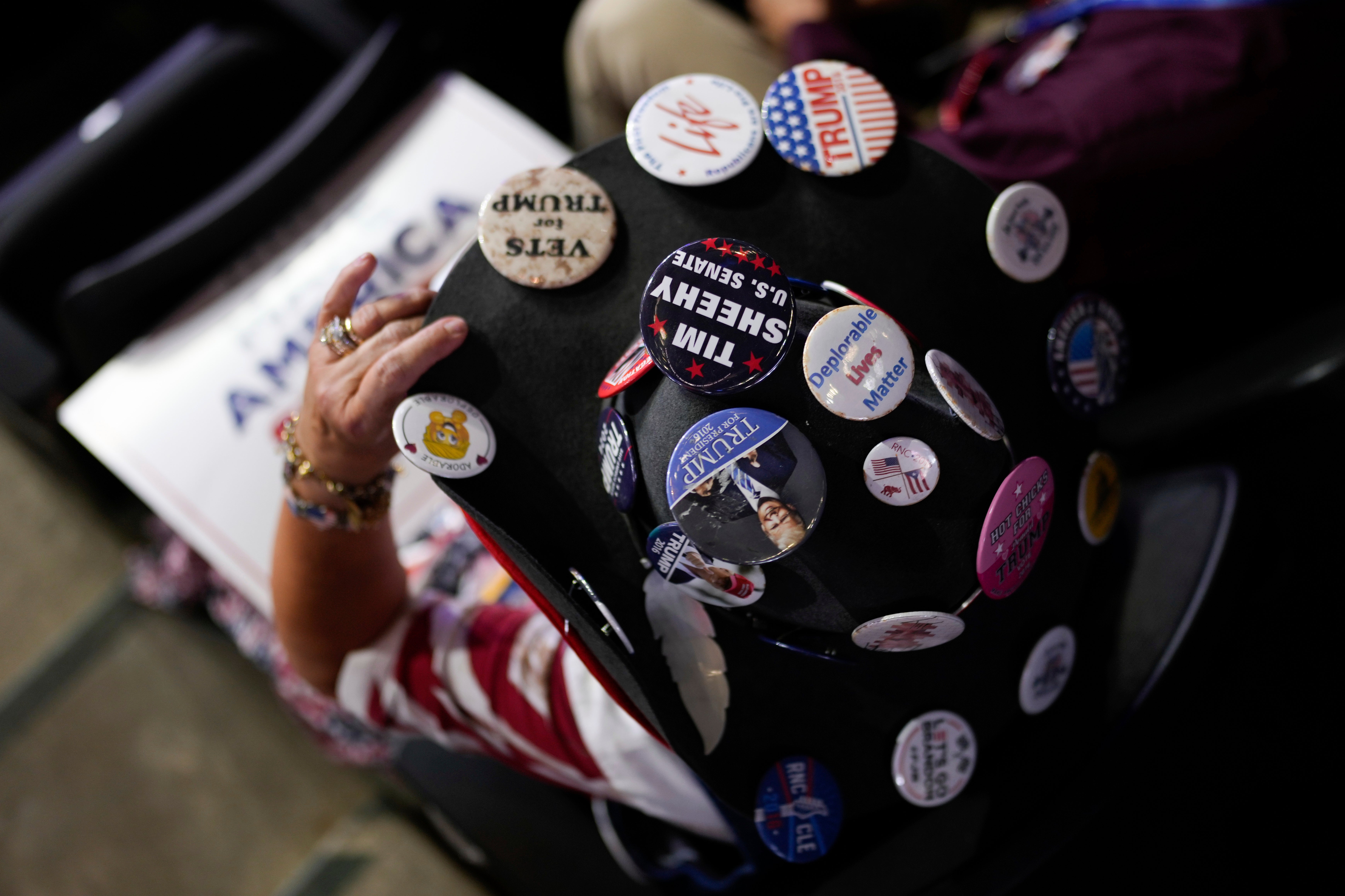 Montana delegate Susan Reneau wears a hat dotted with Trump pins