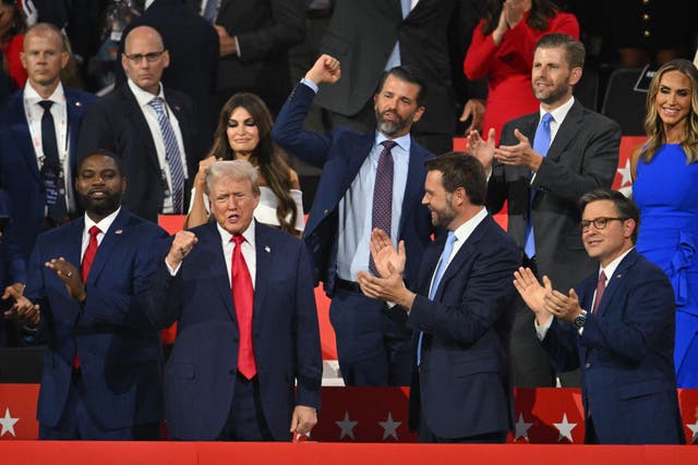 <p>Donald Trump raises a fist during day one of the Republican National Convention in Milwaukee. In the row behind him stand four of his family members; from left to right, Kim Guilfoyle, husband Donald Trump Jr, Eric Trump Jr and his wife, RNC co-chair Lara Trump.</p>