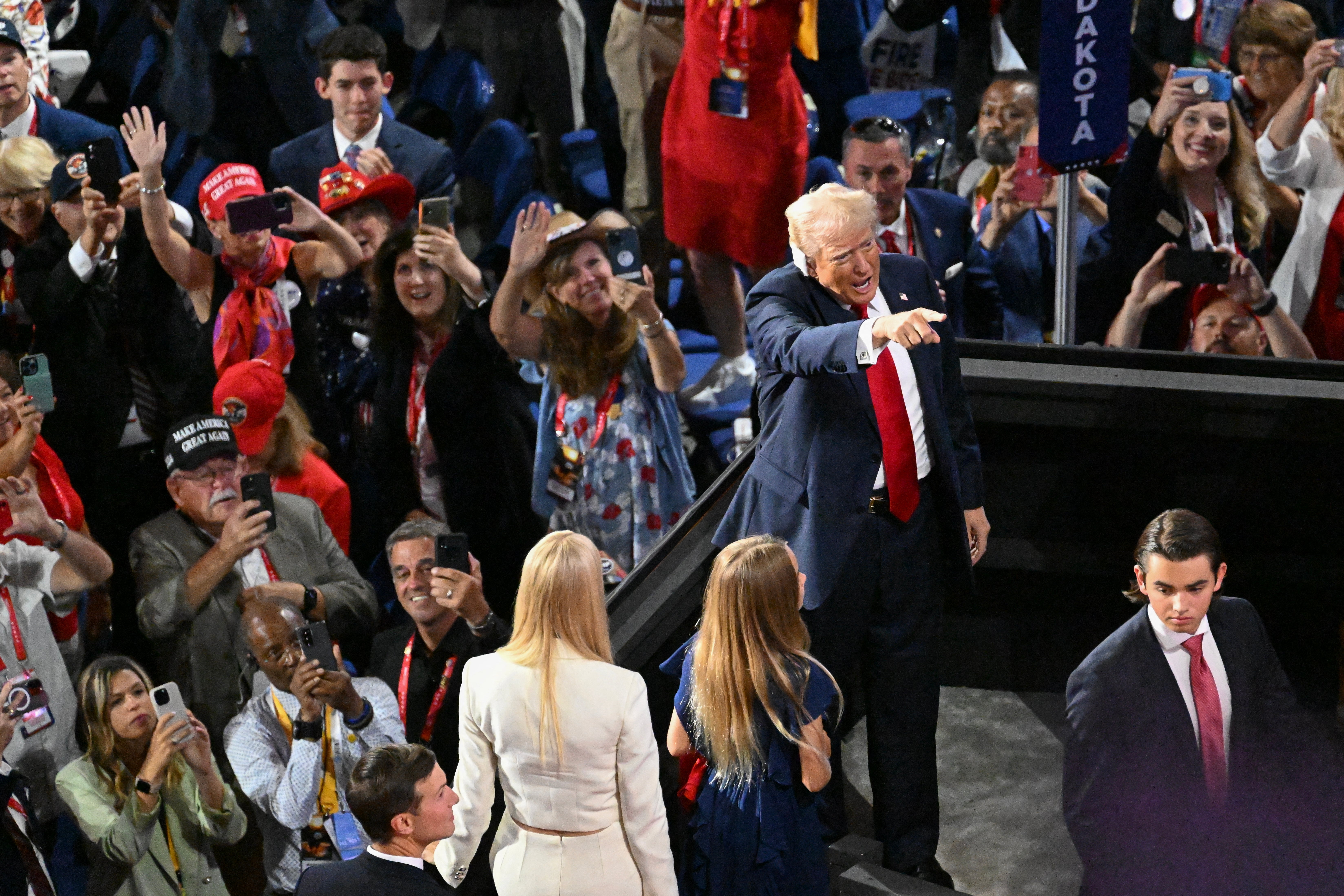 Donald Trump returns to his seat at the RNC with family in tow