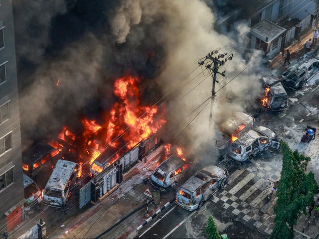 <p>Smoke rises from vehicles set on fire by protesters in Dhaka on 18 July 2024</p>