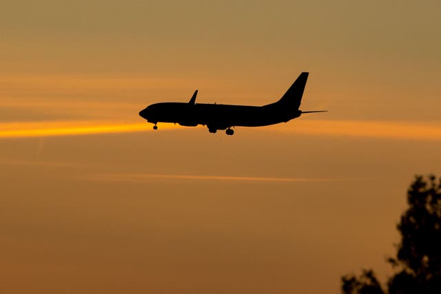 Holidaymakers are being to check their travel insurance cover (Peter Byrne/PA)