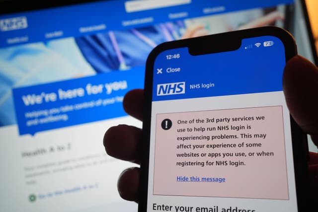 A warning message on the NHS app displayed on a phone as widespread IT outages are affecting businesses and institutions around the globe (Yui Mok/PA)