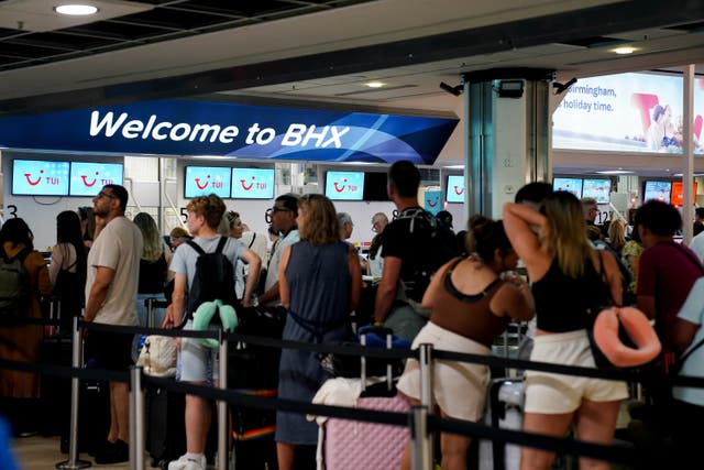 Thousands of airline passengers whose flights have been cancelled due to the global IT outage are being urged to leave crowded airports (Jacob King/PA)