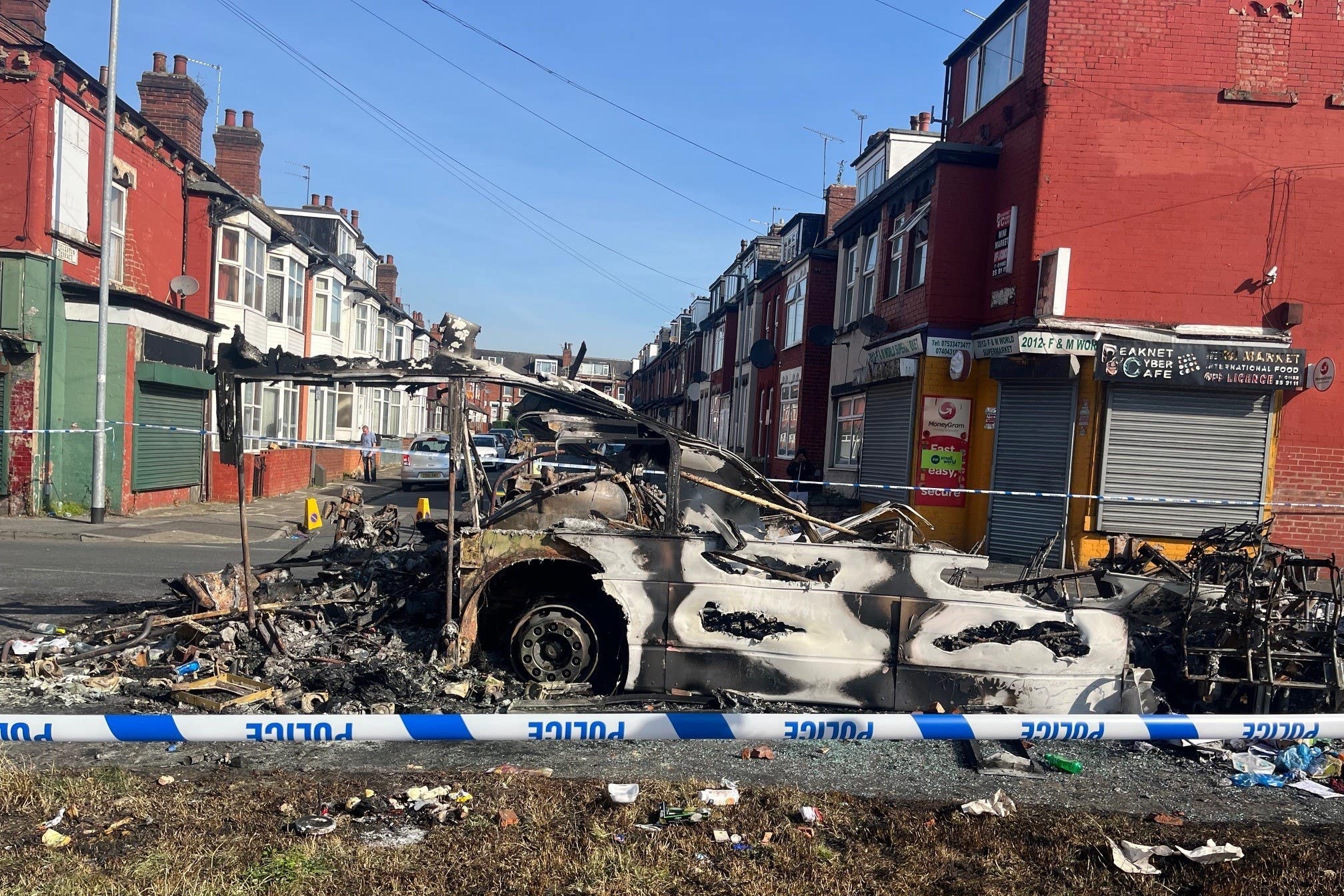 A burnt-out car in the Leeds suburb of Harehills