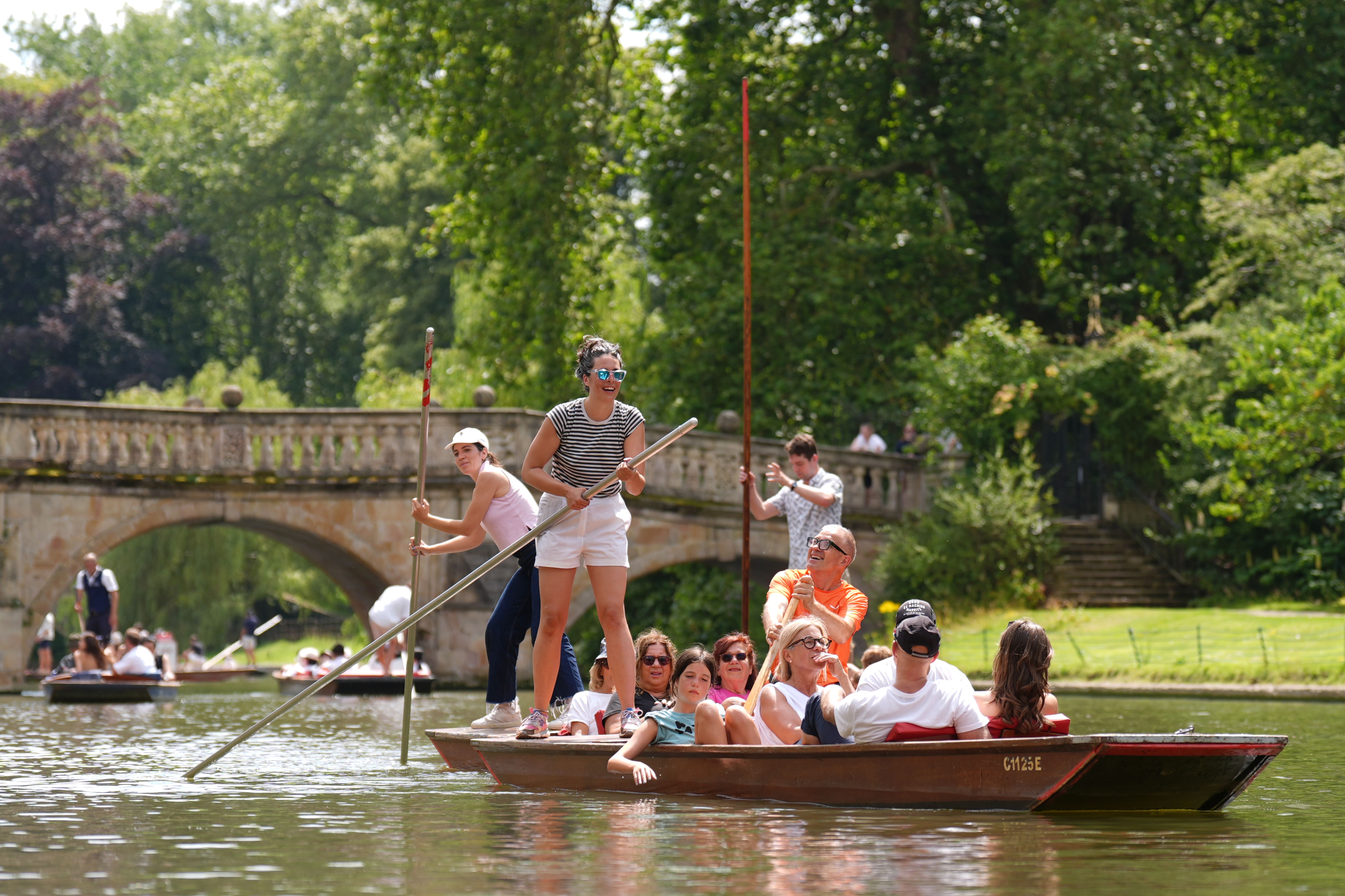 People enjoy the hot weather on a punt tour along the River Cam in Cambridge (Joe Giddens/PA)