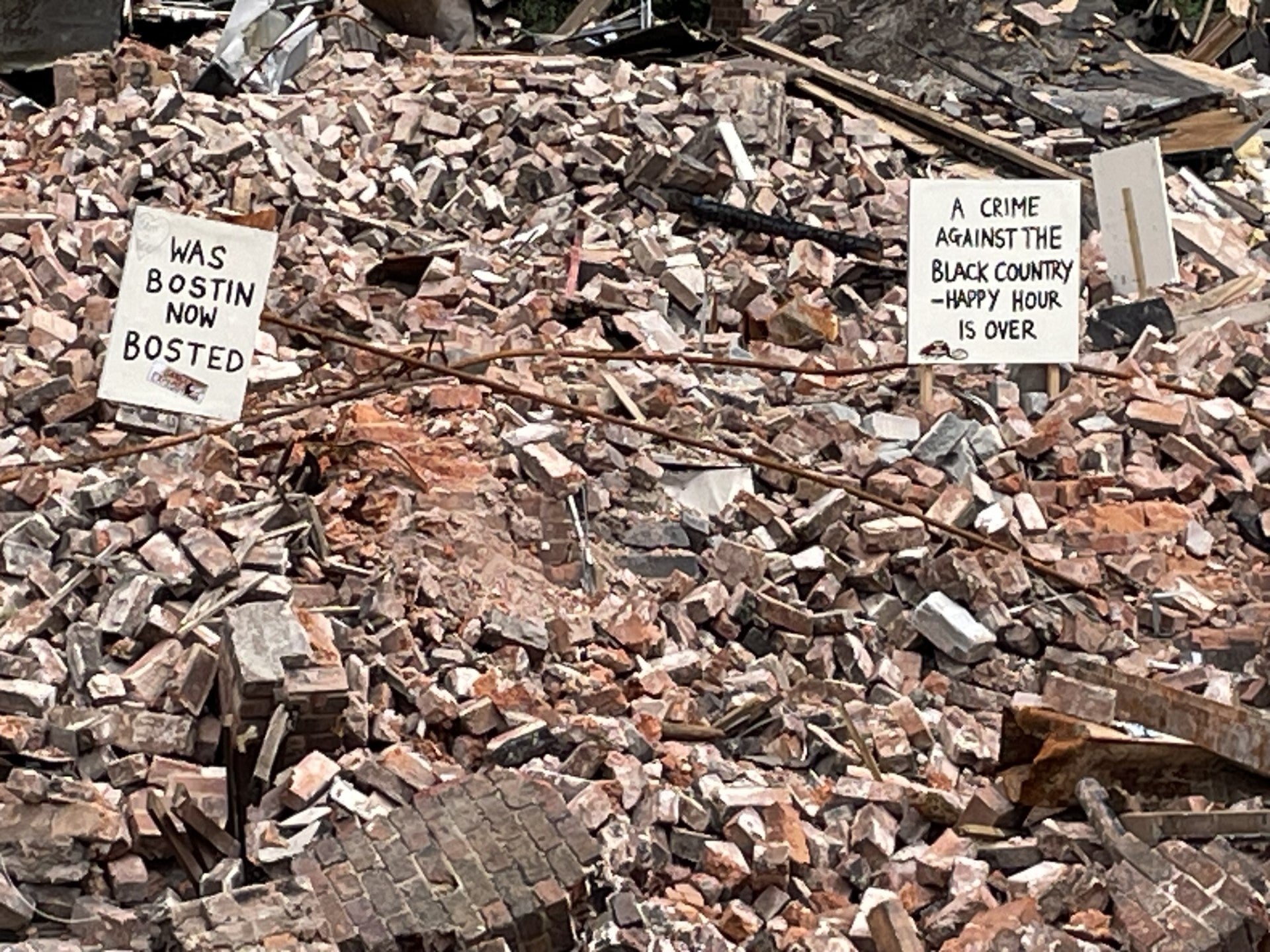 Unhappy locals left posters on the rubble after the pub’s remains were brought down