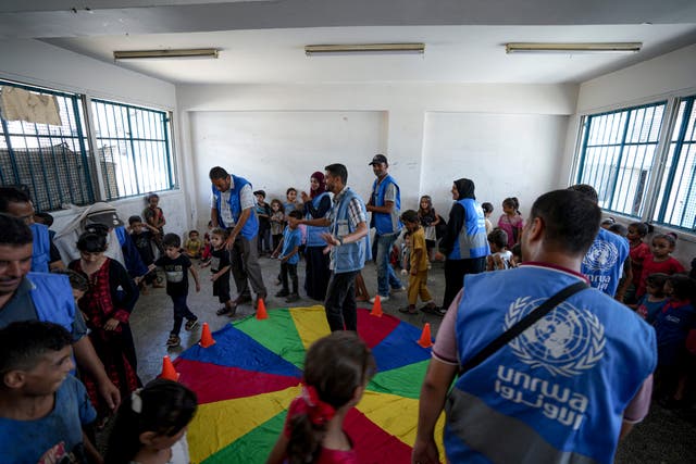 Palestinian children displaced by the Israeli air and ground offensive on the Gaza Strip take part in an activity at a United-Nation run school, in Khan Younis (Abdel Kareem Hana/AP)