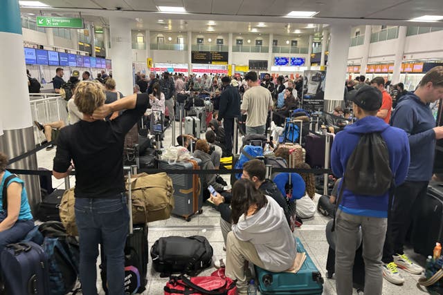 Passengers in the South Terminal at Gatwick Airport amid reports of widespread IT outages (Brian Lawless/PA)