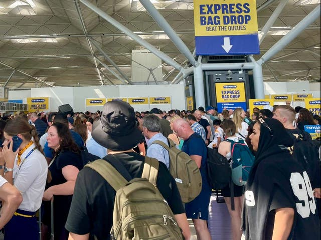 <p>Going places? Passengers queuing at Stansted airport on Friday 19 July </p>
