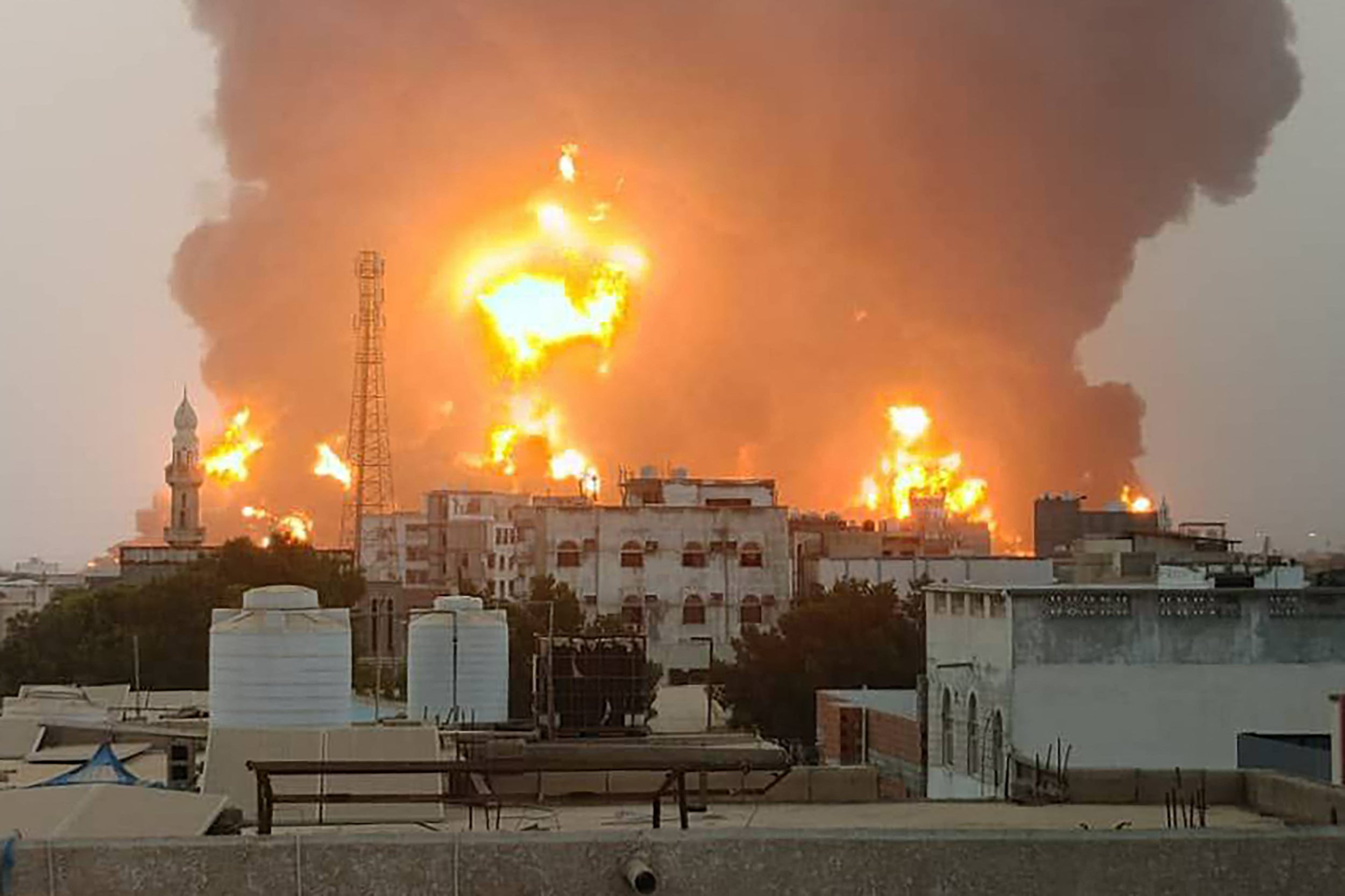 A handout picture obtained from Yemen's Huthi Ansarullah Media Center show a huge column of fire erupting following reported strikes in the Yemeni rebel-held port city of Hodeida opn July 20. Houthi-run media reports the airstrikes were deadly.