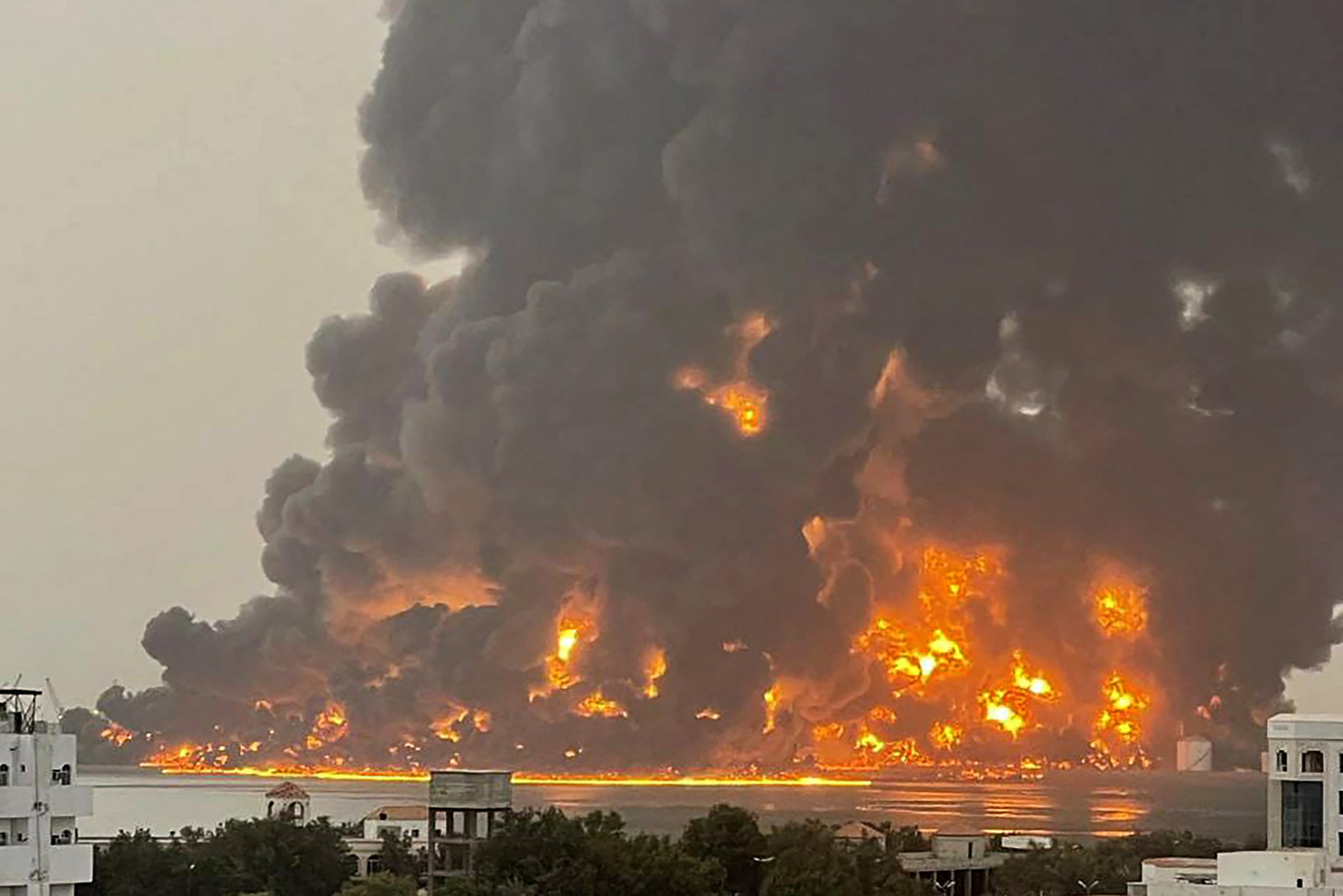 A handout picture obtained from Yemen’s Huthi Ansarullah Media Center shows a column of fire erupting following reported strikes in the port city of Hodeida on July 20