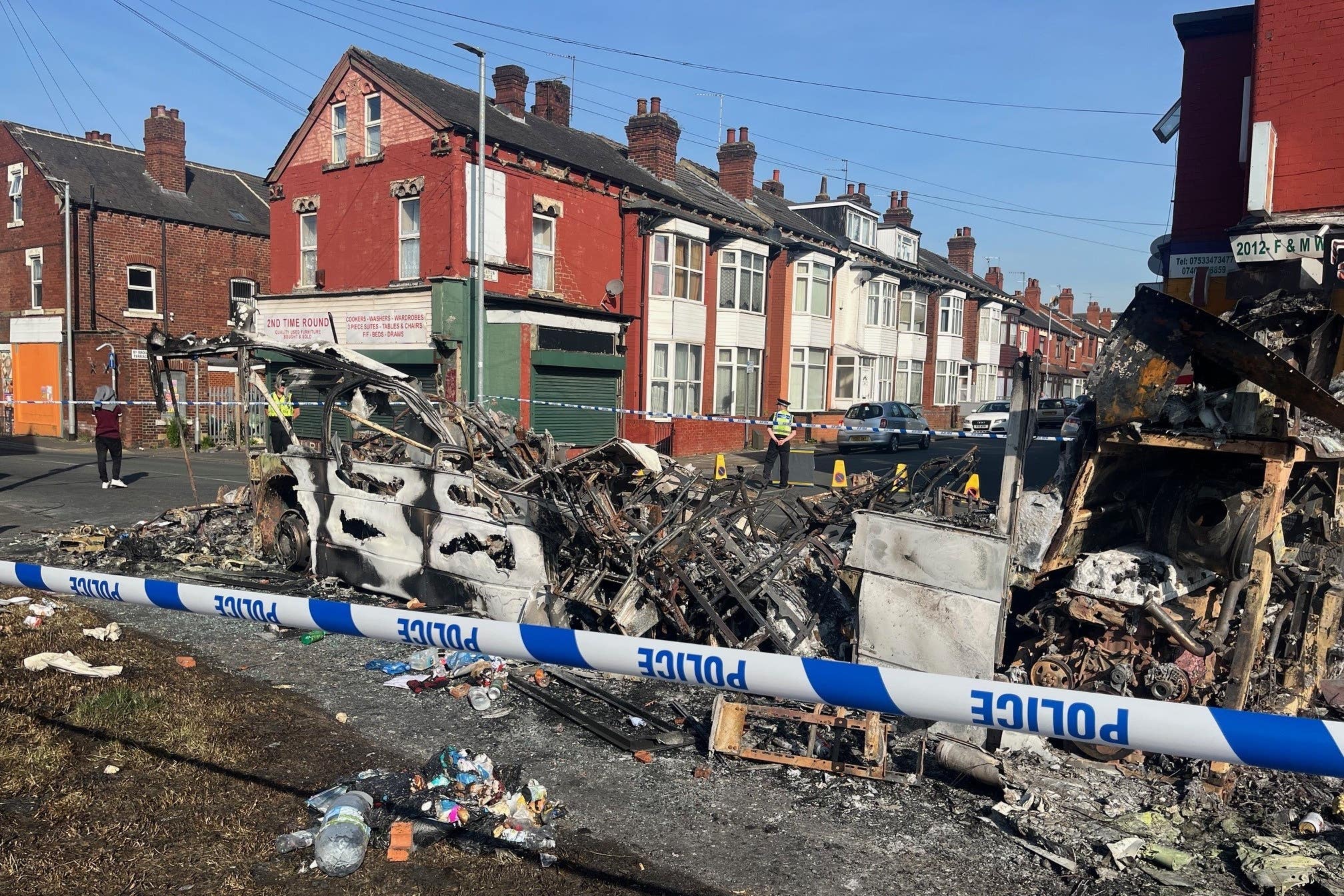 A burnt out car in the Leeds suburb of Harehills (Katie Dickinson/PA)