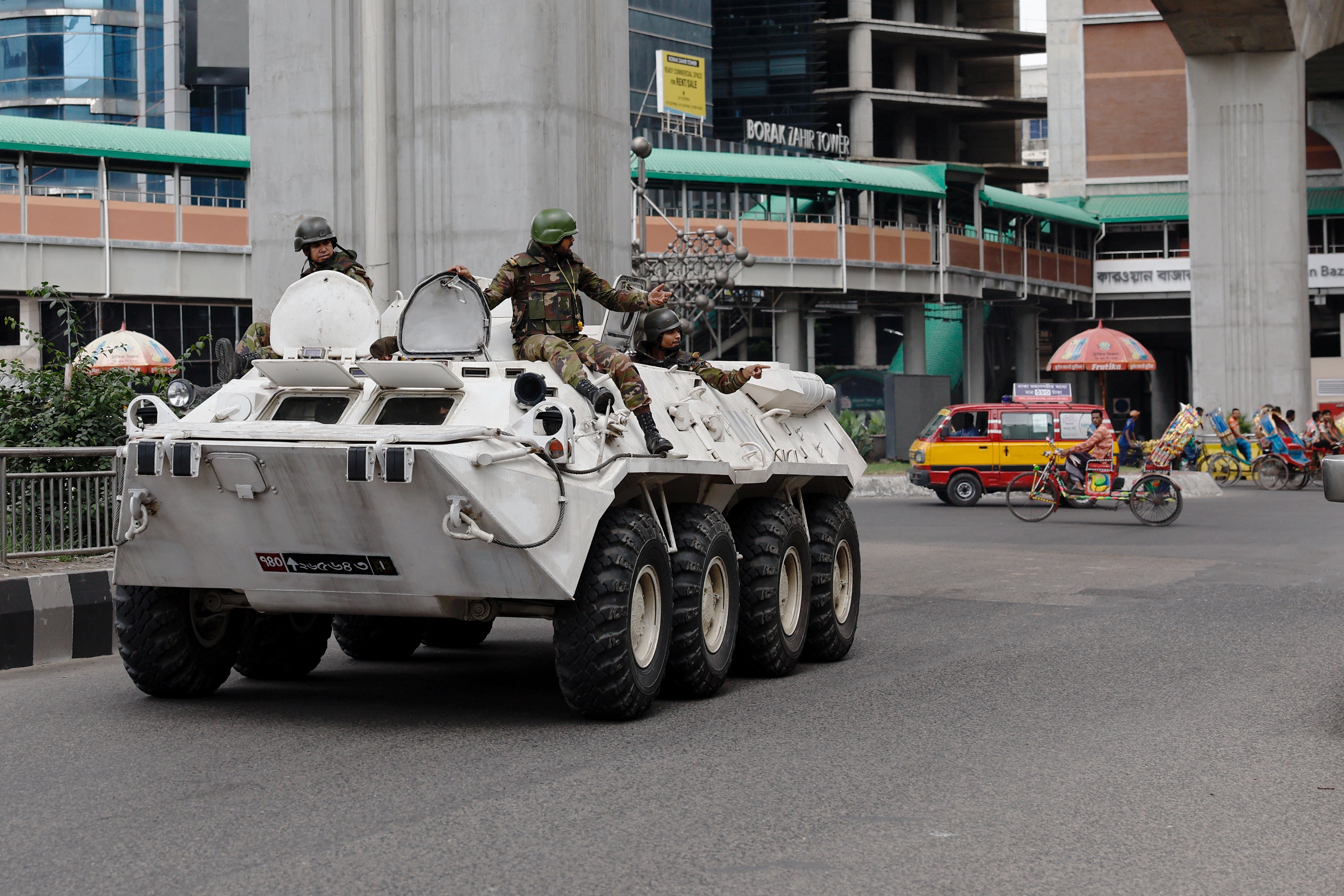 Bangladesh Army soldiers patrol in an armoured vehicle on the second day of curfew, as violence erupted in parts of the country after protests by students against government job quotas