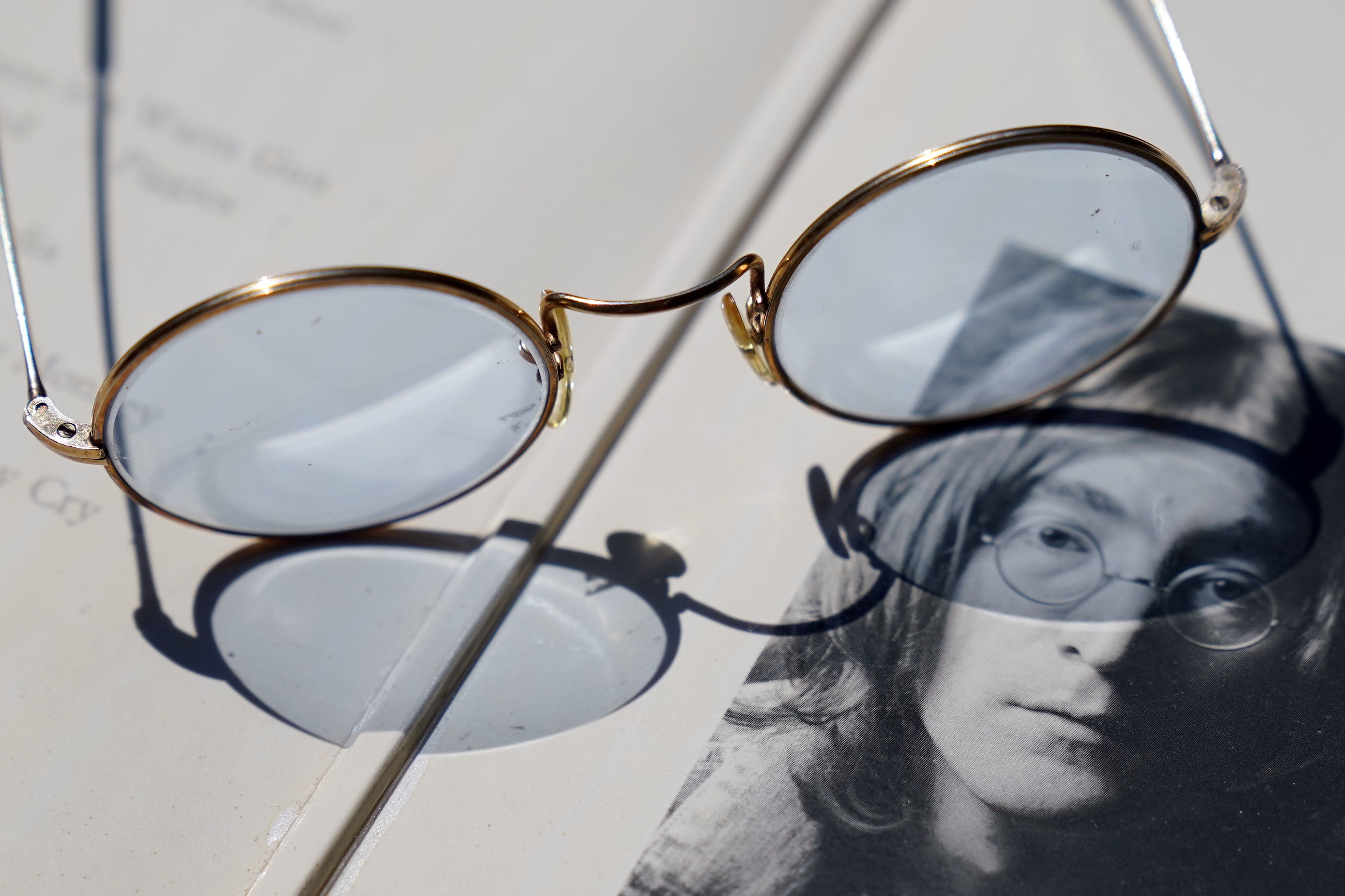 A pair of round blue tinted John Lennon-style glasses which were gifted by the late musician and will be offered for auction (Gareth Fuller/PA)