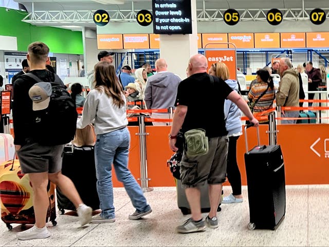 <p>Going places: EasyJet passengers at Manchester airport</p>