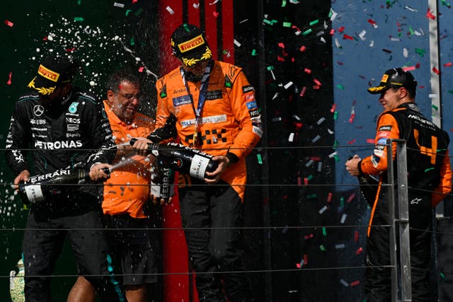 Oscar Piastri, centre, joined Lewis Hamilton, left, and Lando Norris among seven different race winners this season (Denes Erdos/AP)